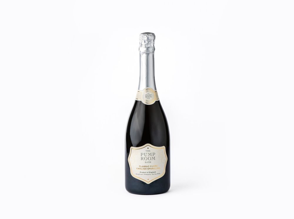 Elegant silver-labeled champagne bottle with dark glass and foil wrap.