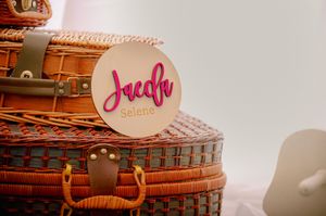 Vintage style suitcases and pink decorative elements arranged on white background.