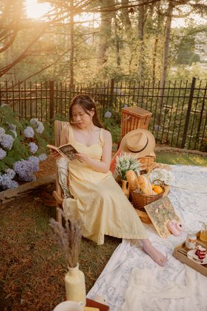 A peaceful garden picnic scene with hydrangeas, wicker baskets and summer refreshments.