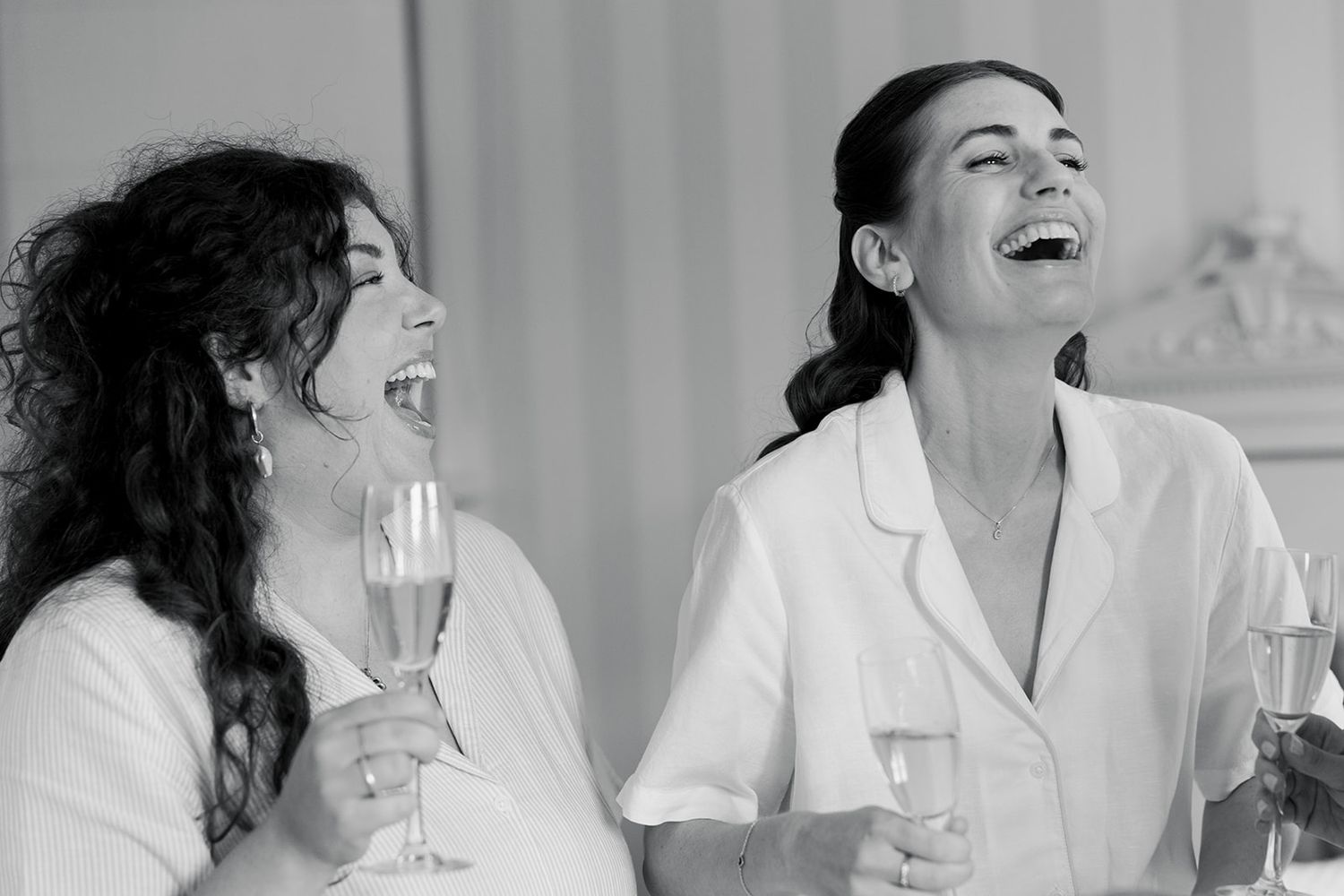 A black and white photo series showing a person laughing and expressing various joyful emotions.