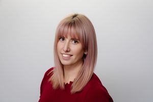 Collection of headshots showing woman with pink hair against light gray background wearing burgundy top.