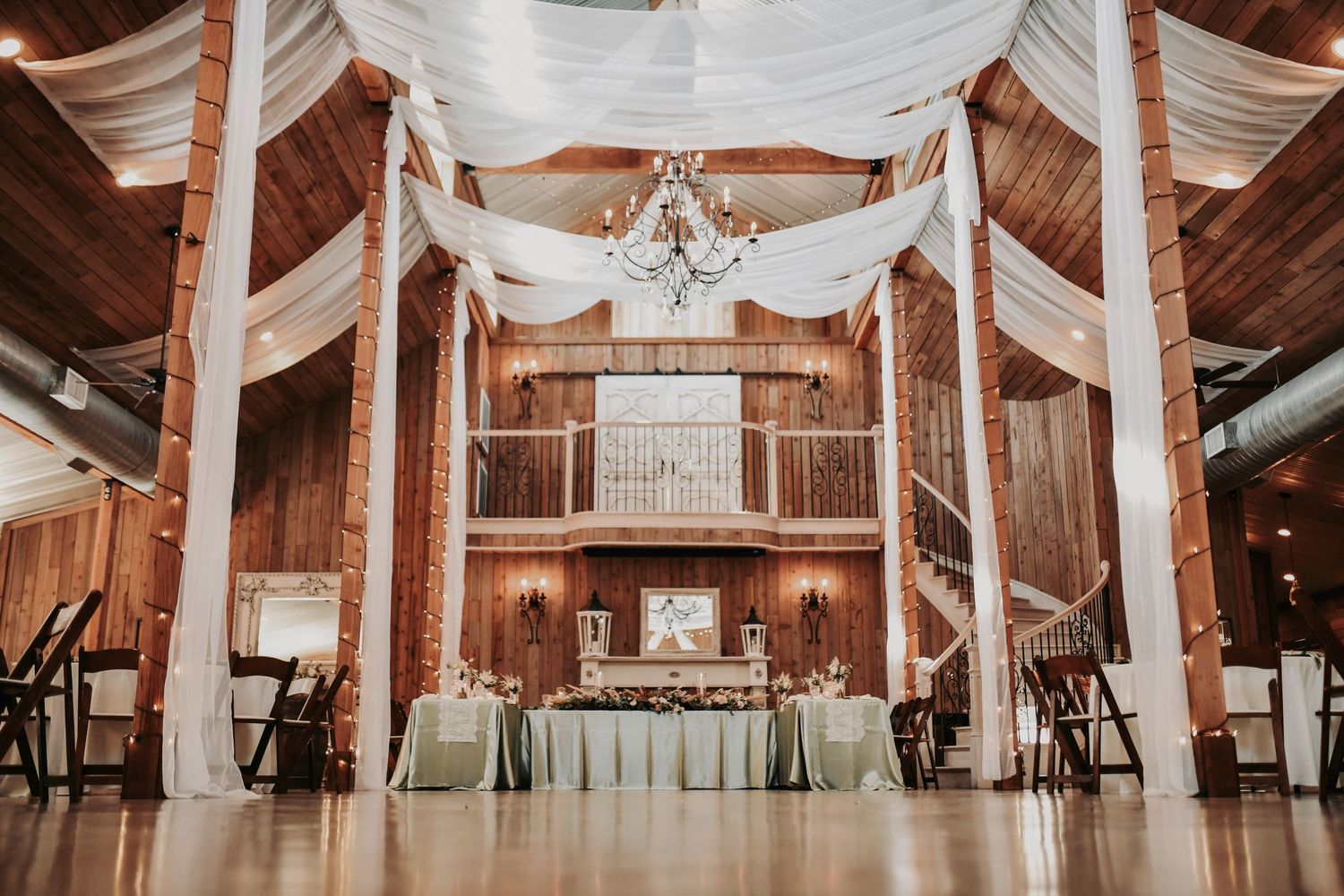 Whispering Oaks wedding reception table details with green accents and romantic candlelight