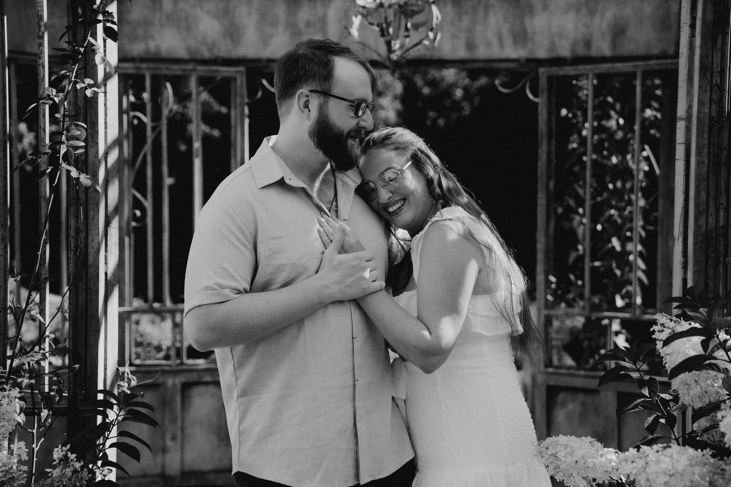 An intimate black and white portrait of a couple sharing a tender moment together.