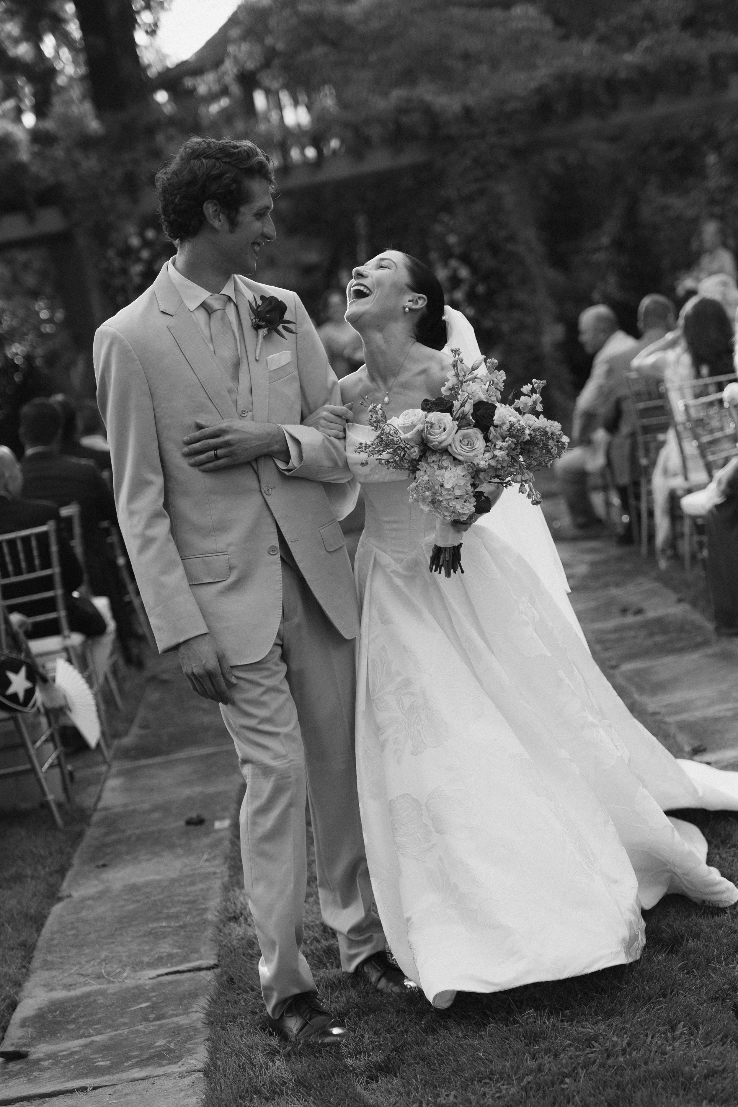 Wedding couple shares joyful moments during their outdoor celebration.