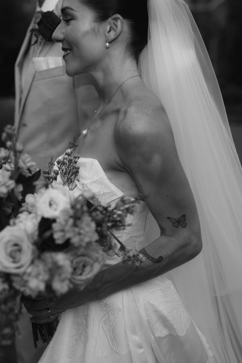 Black and white sequence of a bride with flowers and veil sharing an intimate moment.