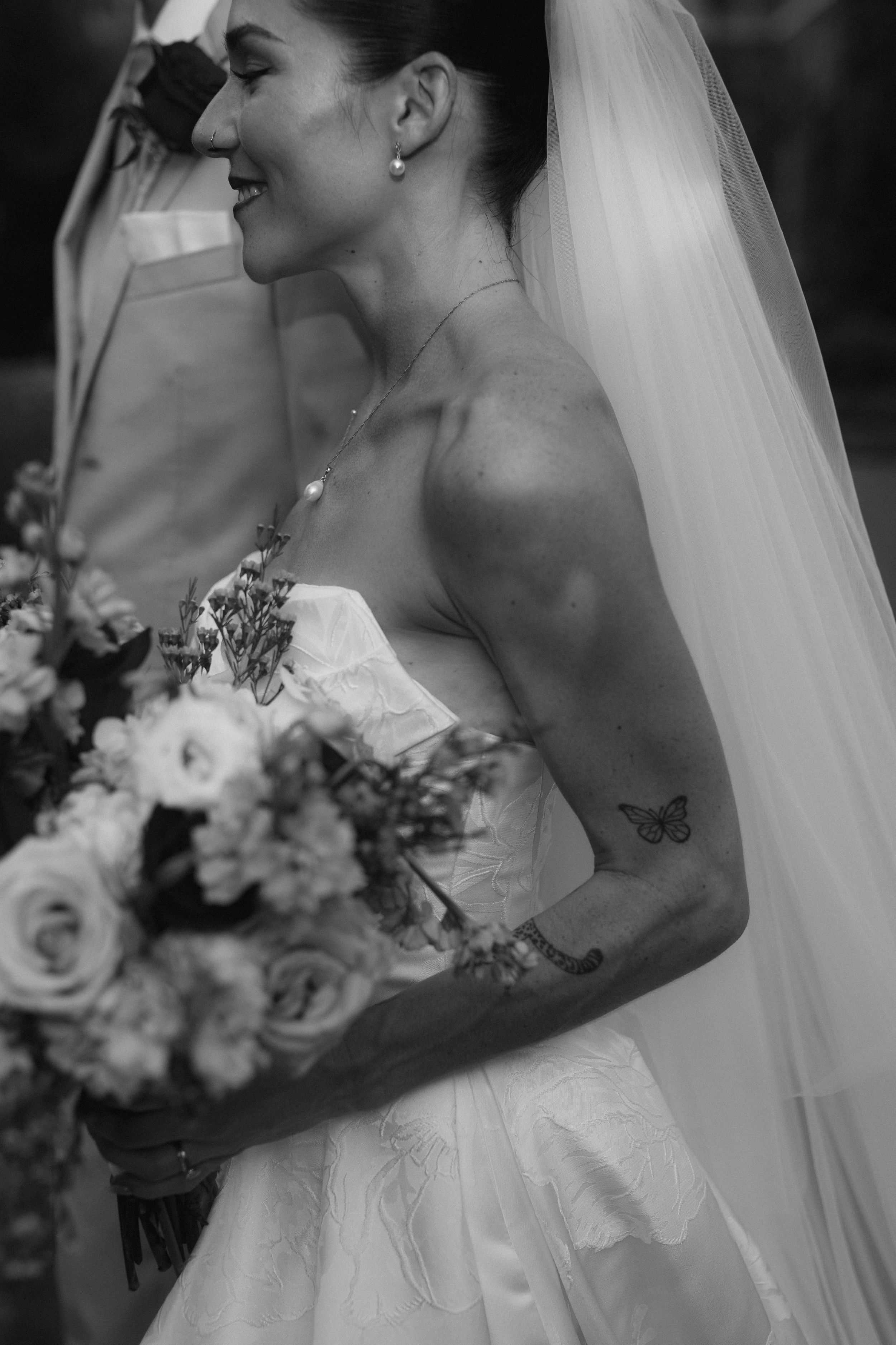 Black and white sequence of a bride with flowers and veil sharing an intimate moment.