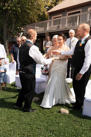 Wedding celebration sequence showing couple and guests dancing outdoors on grass.