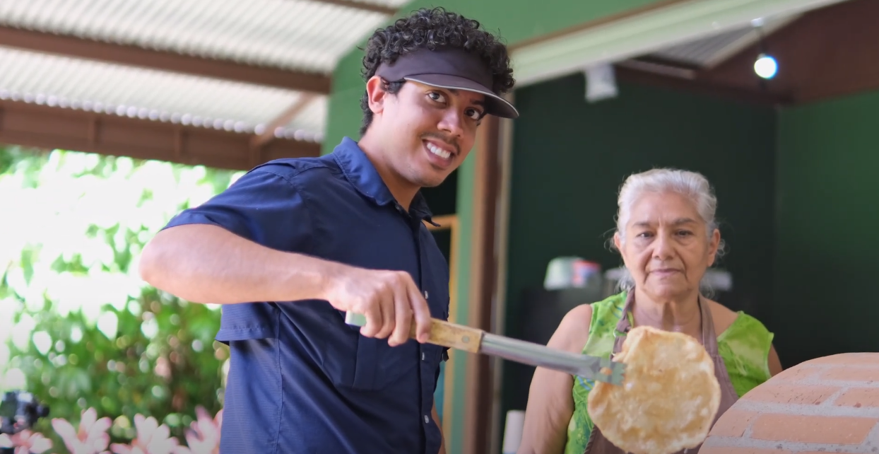Traditional coconut preparation demonstration at a tropical food workshop.