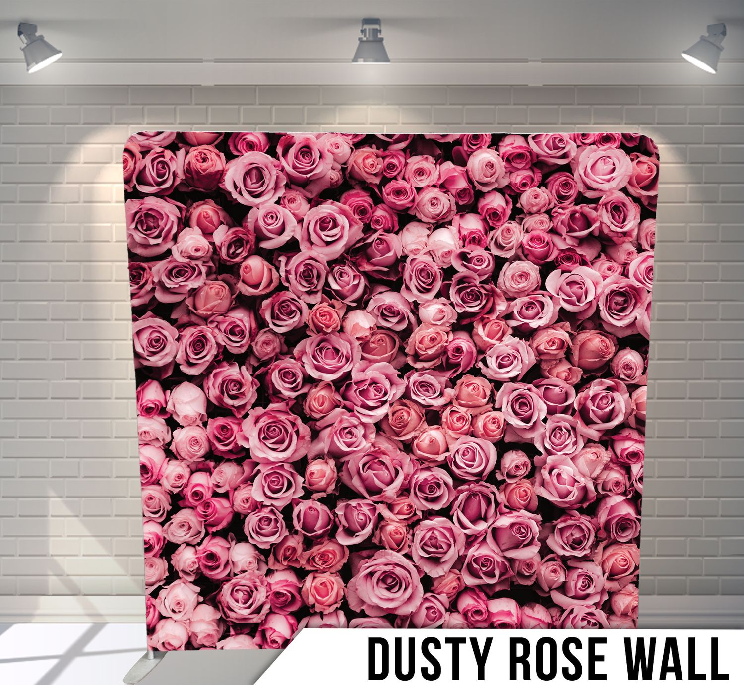 Dusty rose floral wall installation in progress showing sequential assembly stages of pink roses on white brick surface.