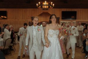 Wedding reception scene with couples dancing in an elegantly decorated banquet hall.