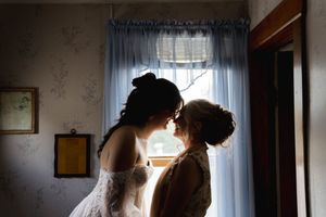 Backlit figures create dramatic silhouettes against bright window light.