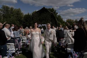 Wedding celebration in a garden setting with guests mingling outdoors.