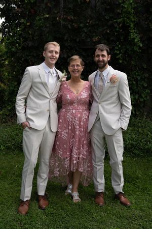 Group photo of wedding party members in coordinated white and pink attire.