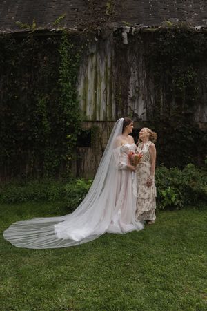 Wedding photos taken against rustic wooden wall backdrop with flowing white veil details.