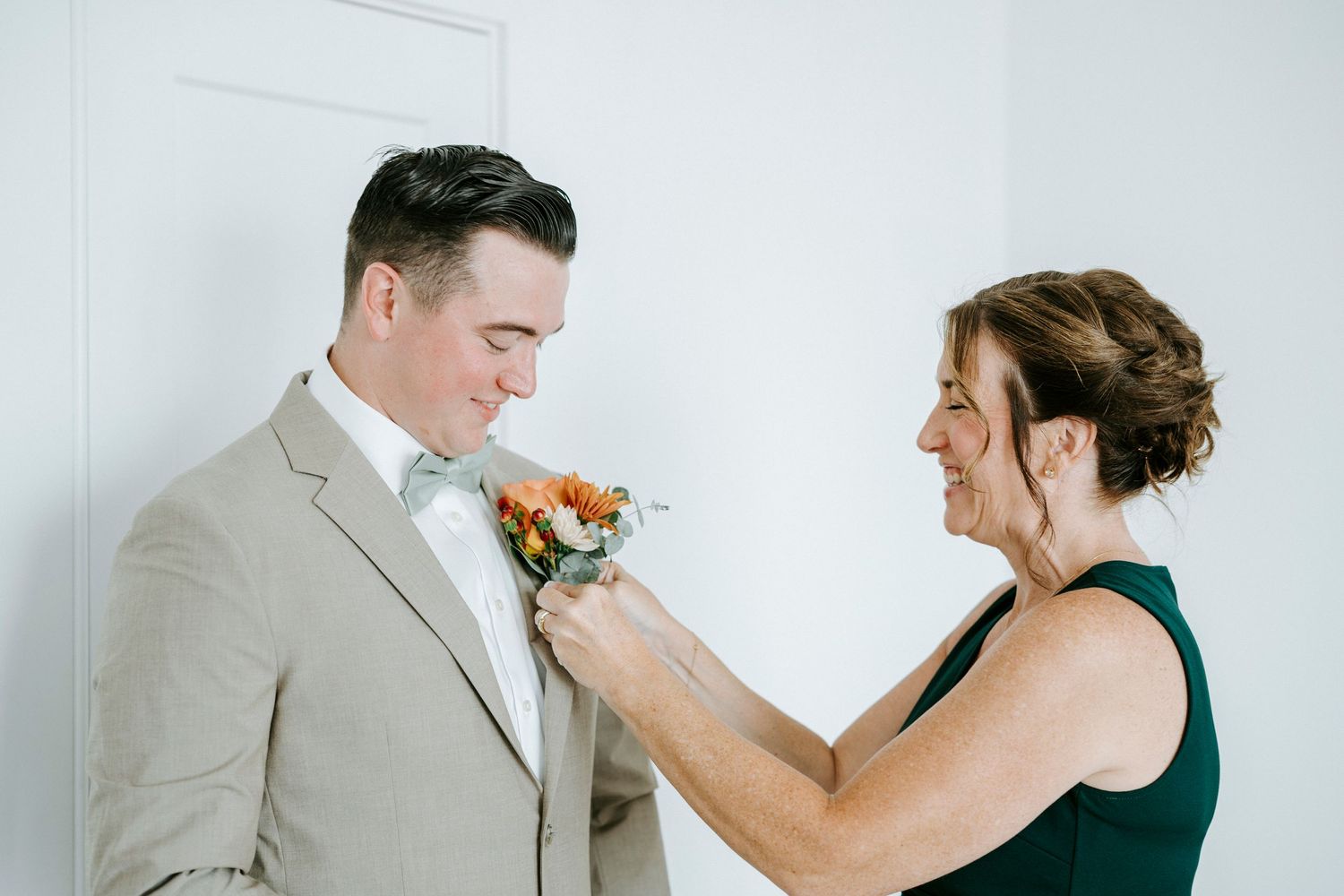 Two people are shown sharing a heartfelt moment as one wipes tears away from the other's face in a touching display.