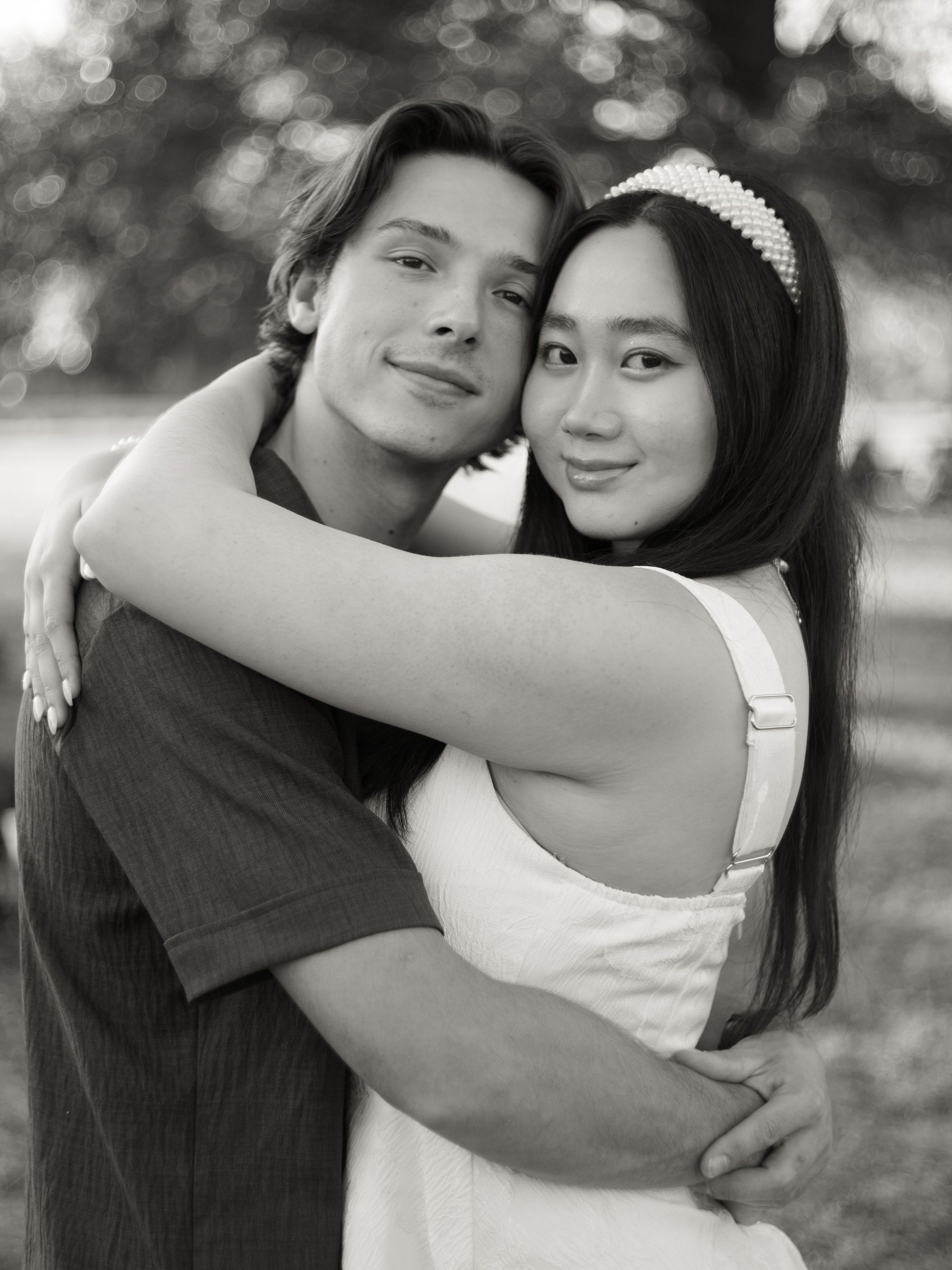 A romantic black and white photo series showing tender embraces between a couple in an outdoor setting.