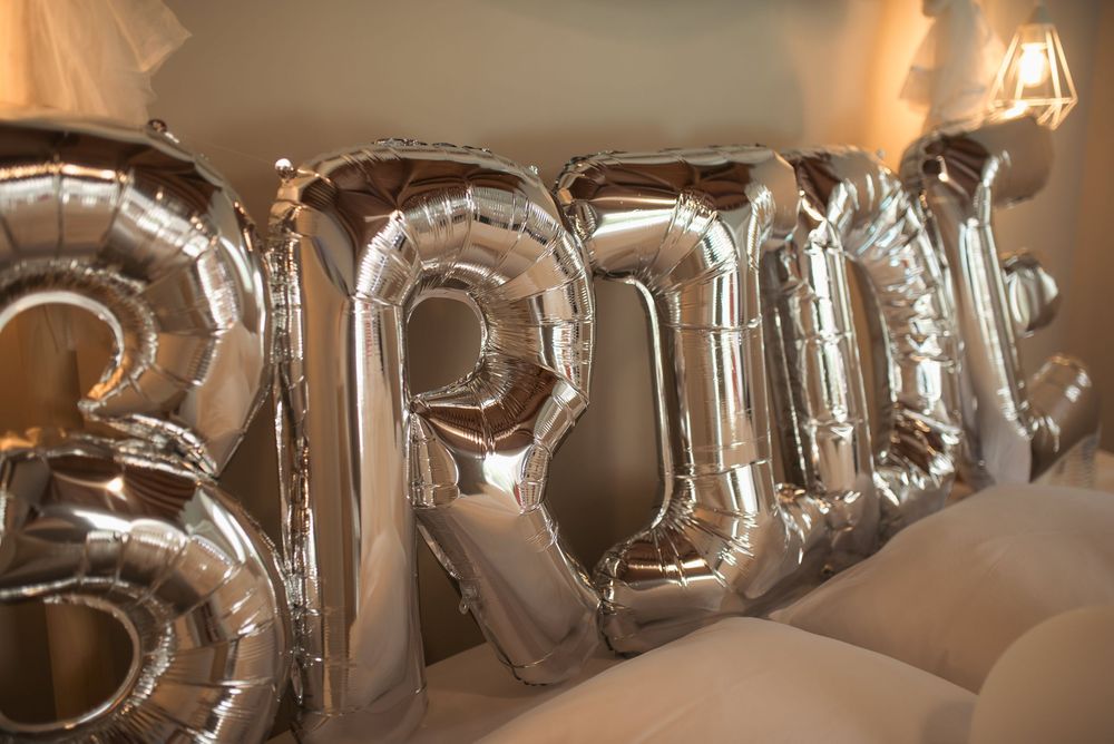 Silver balloon letters spelling out text for wedding celebration decoration.