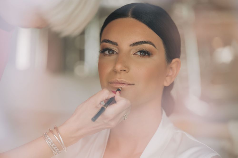Closeup shots of bridal makeup application and styling.