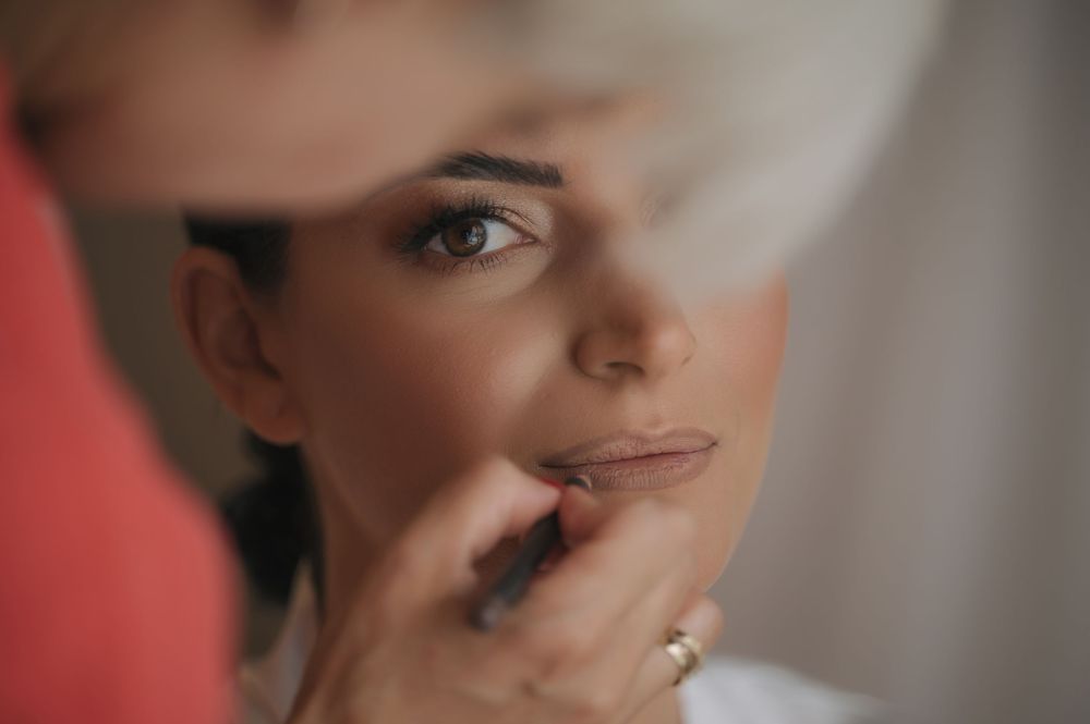 Soft focus portrait with elegant makeup and jewelry details.