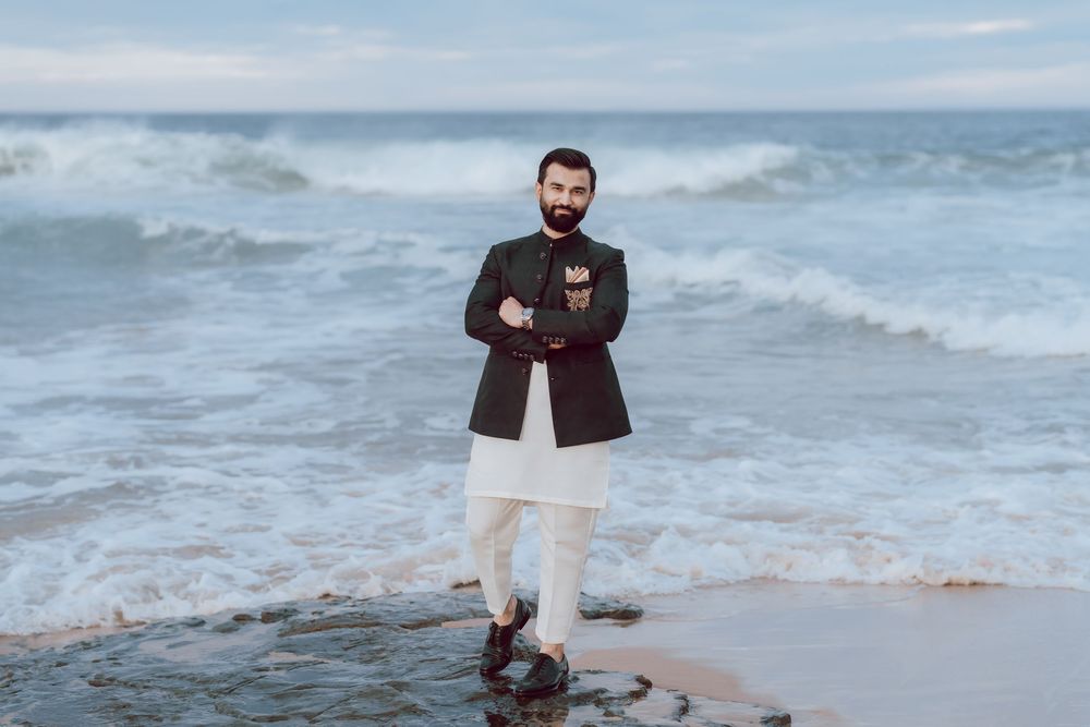 Multiple shots of someone wearing black and beige clothing posing on a scenic beach with crashing waves.