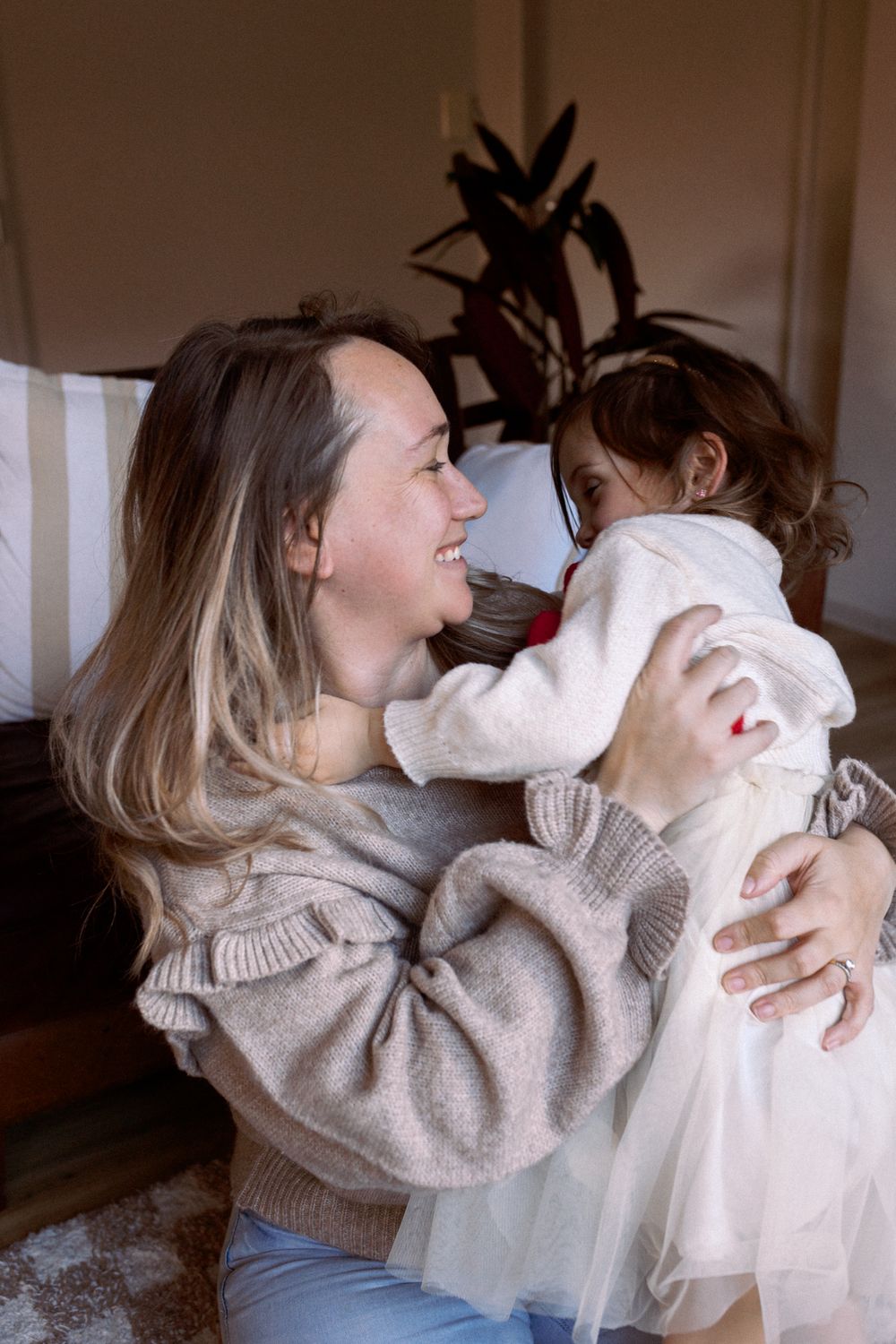 A series of candid shots showing loving embraces in warm neutral sweaters.