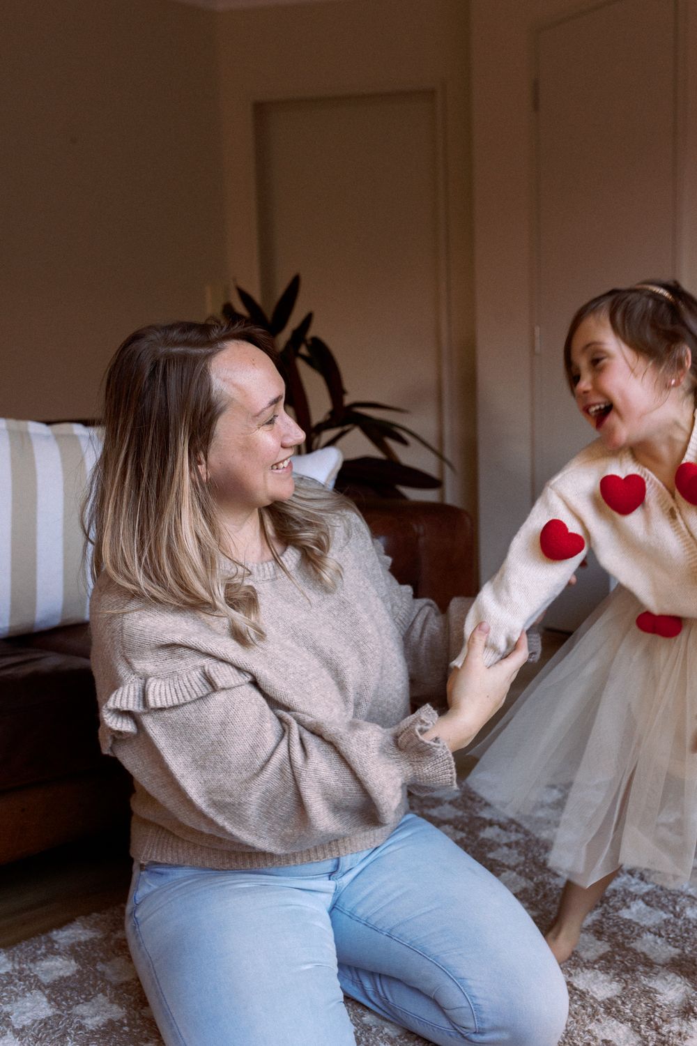 A sequence showing playful interactions on a sofa with a small toy heart decoration.