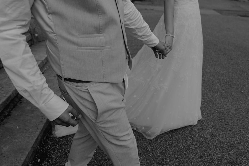Black and white photo showing formal wedding attire details.