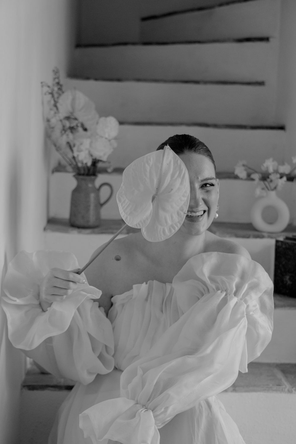 Series of playful black and white photos showing someone in a flowing white dress.