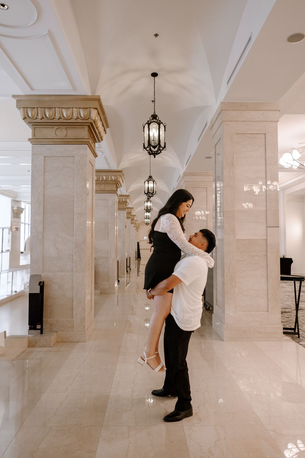 A sequence of candid dance poses captured in an elegant marble hallway with hanging lanterns.