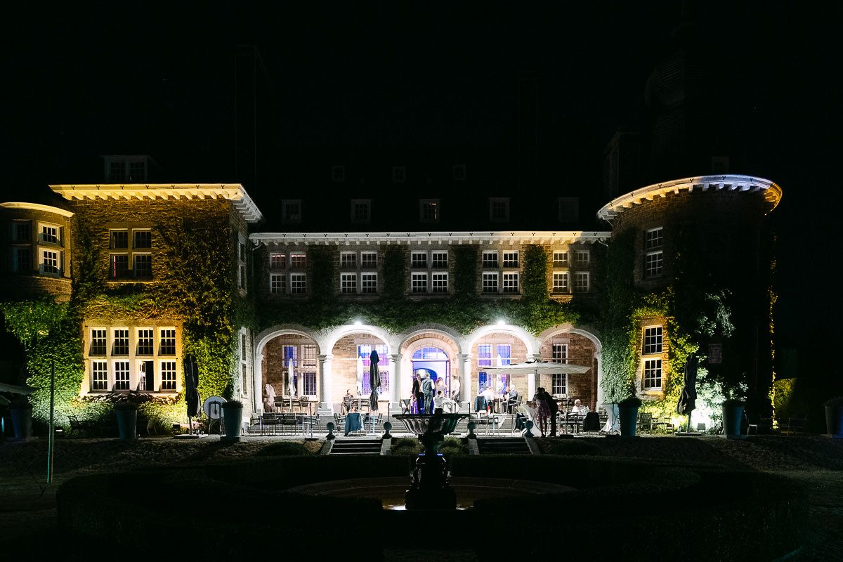 Night view of illuminated Manoir de Lébioles castle facade