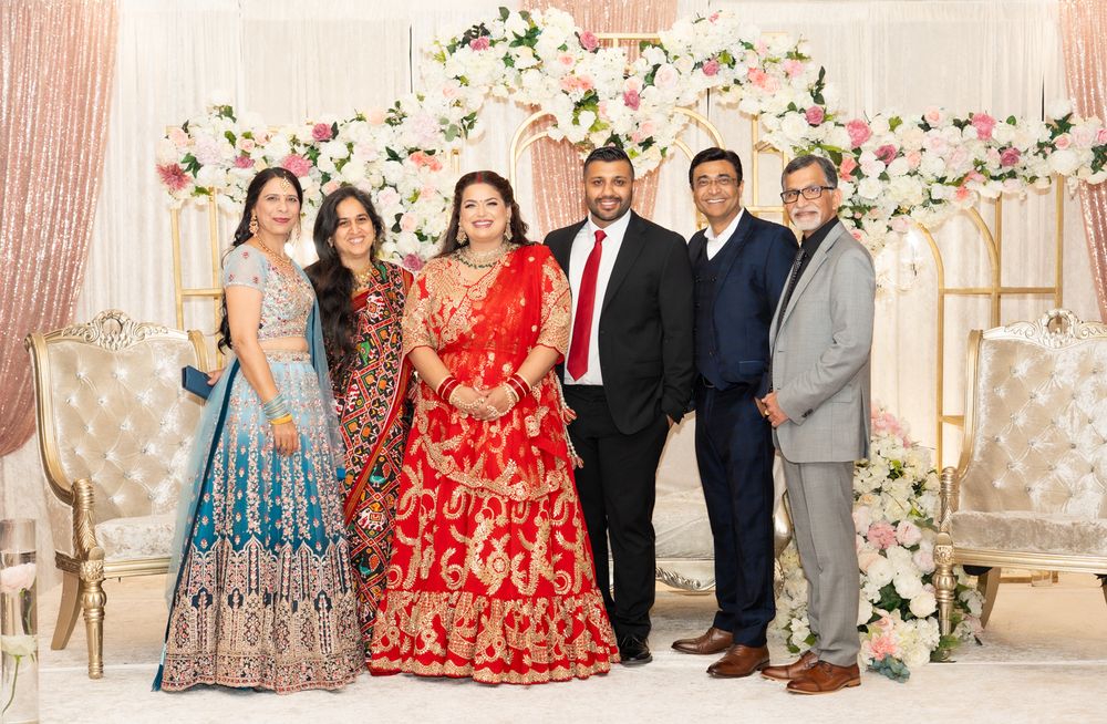 A panoramic view of a wedding celebration with floral decorations and guests in formal attire at an elegant venue.