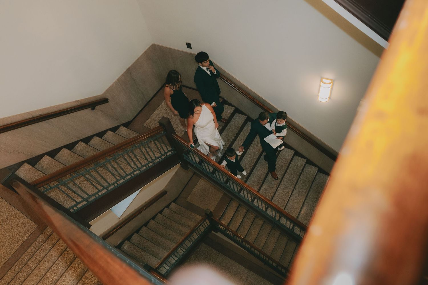 A sequential series of images showing someone walking down old wooden stairs and taking photos of the scene.