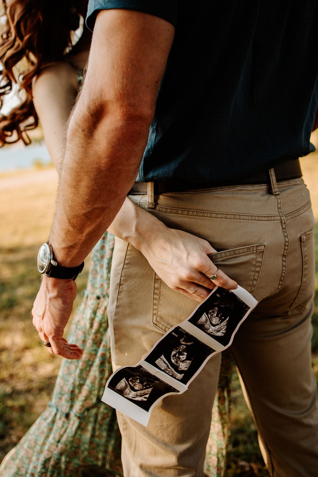 Couple announcing pregnancy during scenic Lake Travis session in Austin, Texas from an Austin Family Photographer