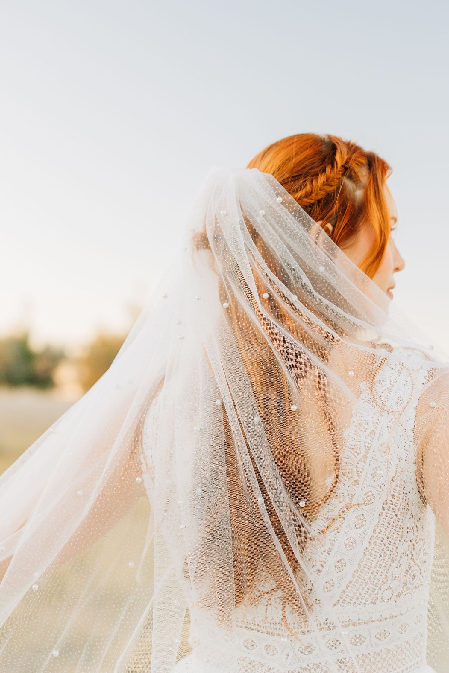 bridal images of a bride in a long veil with red hair at bountiful pond