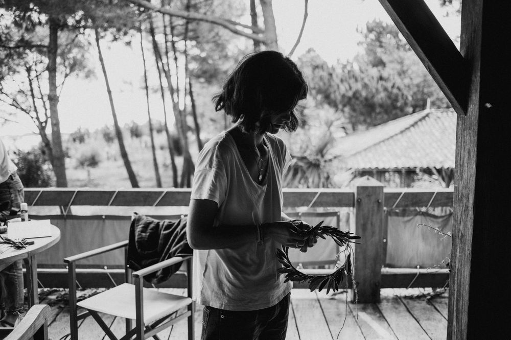Silhouette of someone cooking outdoors on a deck during golden hour.