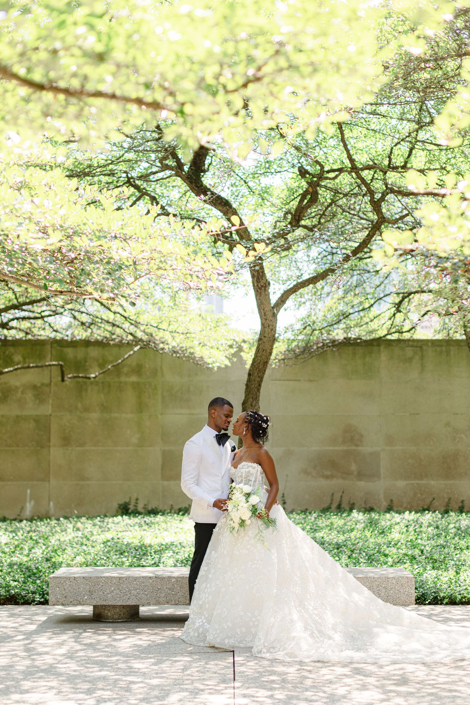A romantic wedding portrait underneath blooming spring trees.