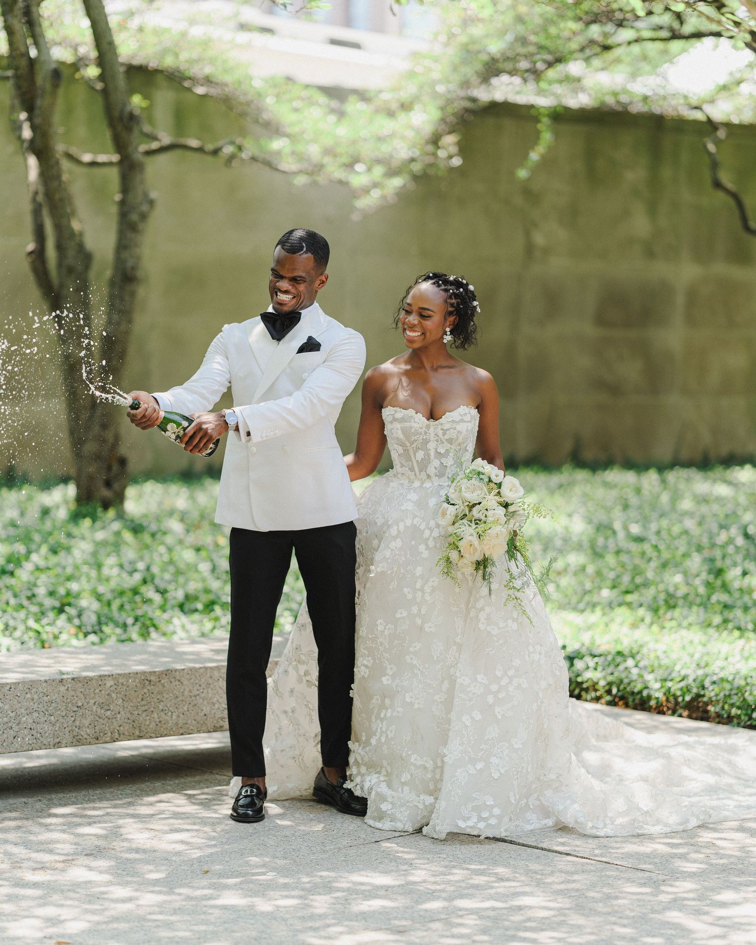 A joyful wedding celebration moment captured in a garden setting.