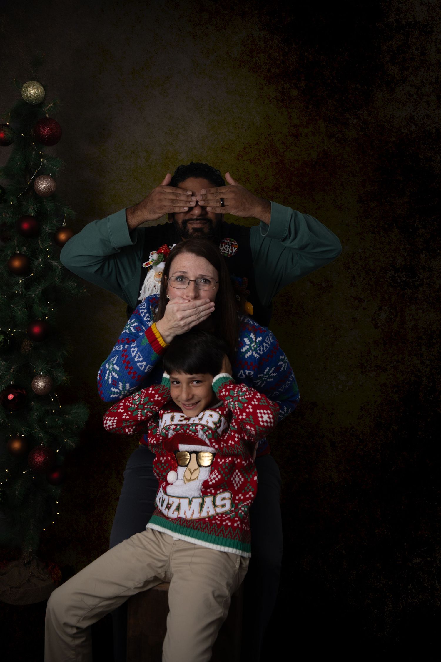 Holiday portrait of couple in matching santa print shirts with christmas decorations with Nashville family photographer