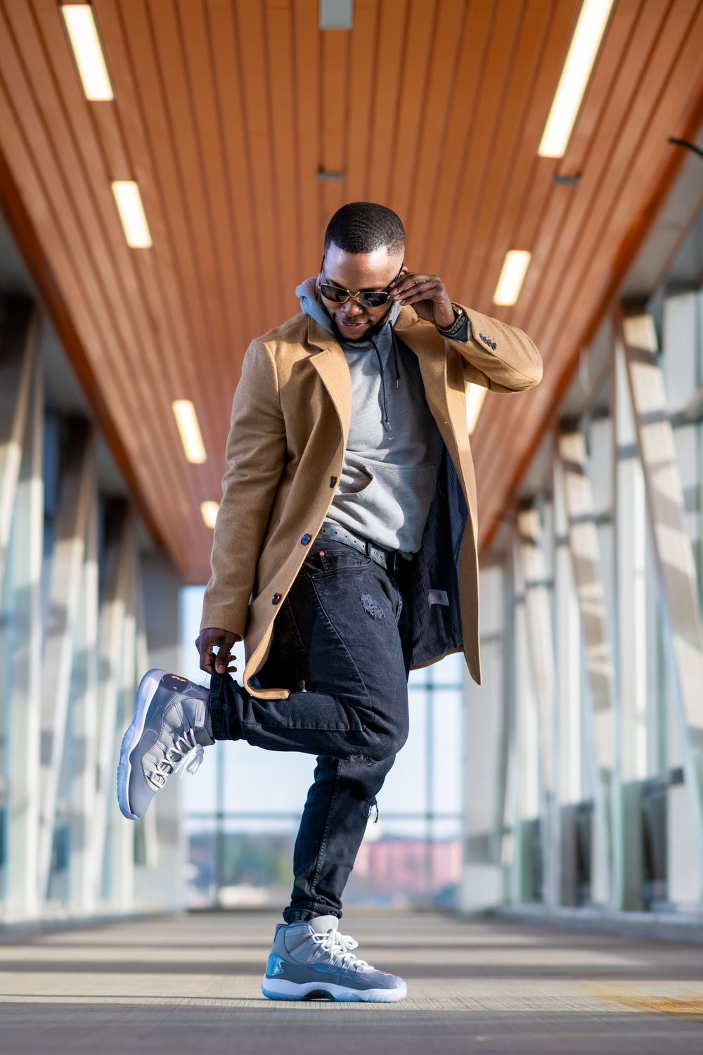 Series of low-angle shots showing sneakers and dress pants in an architectural corridor setting.