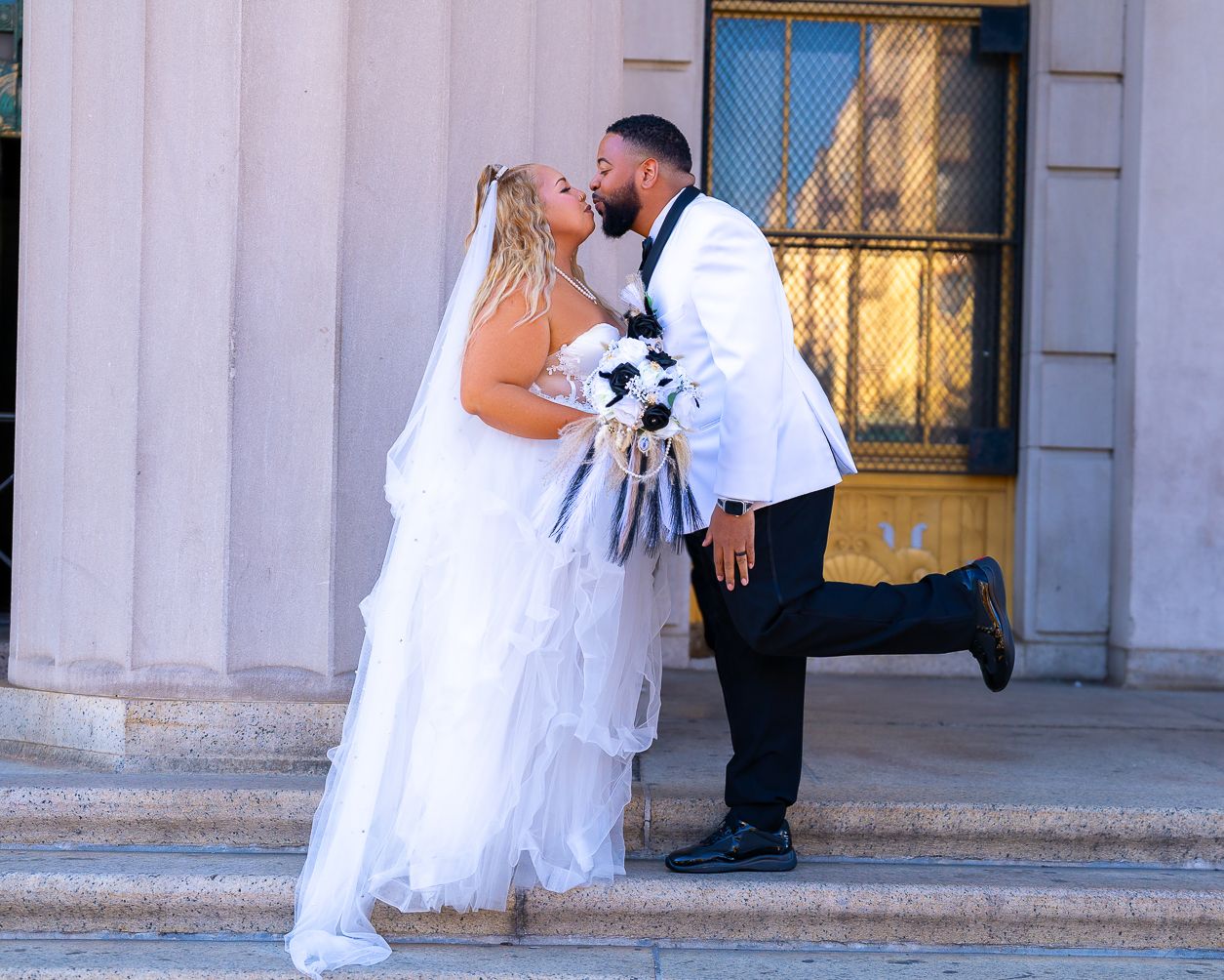 Series of wedding photos showing a bride and groom in romantic poses outside a grand building entrance.