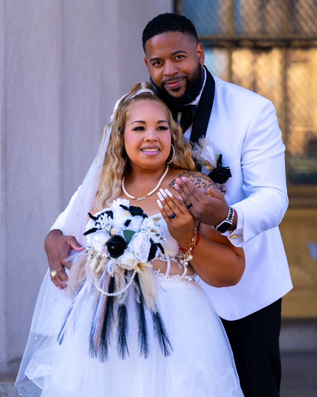 A couple shares playful moments and poses during a formal photo session, with the bride wearing a white dress.