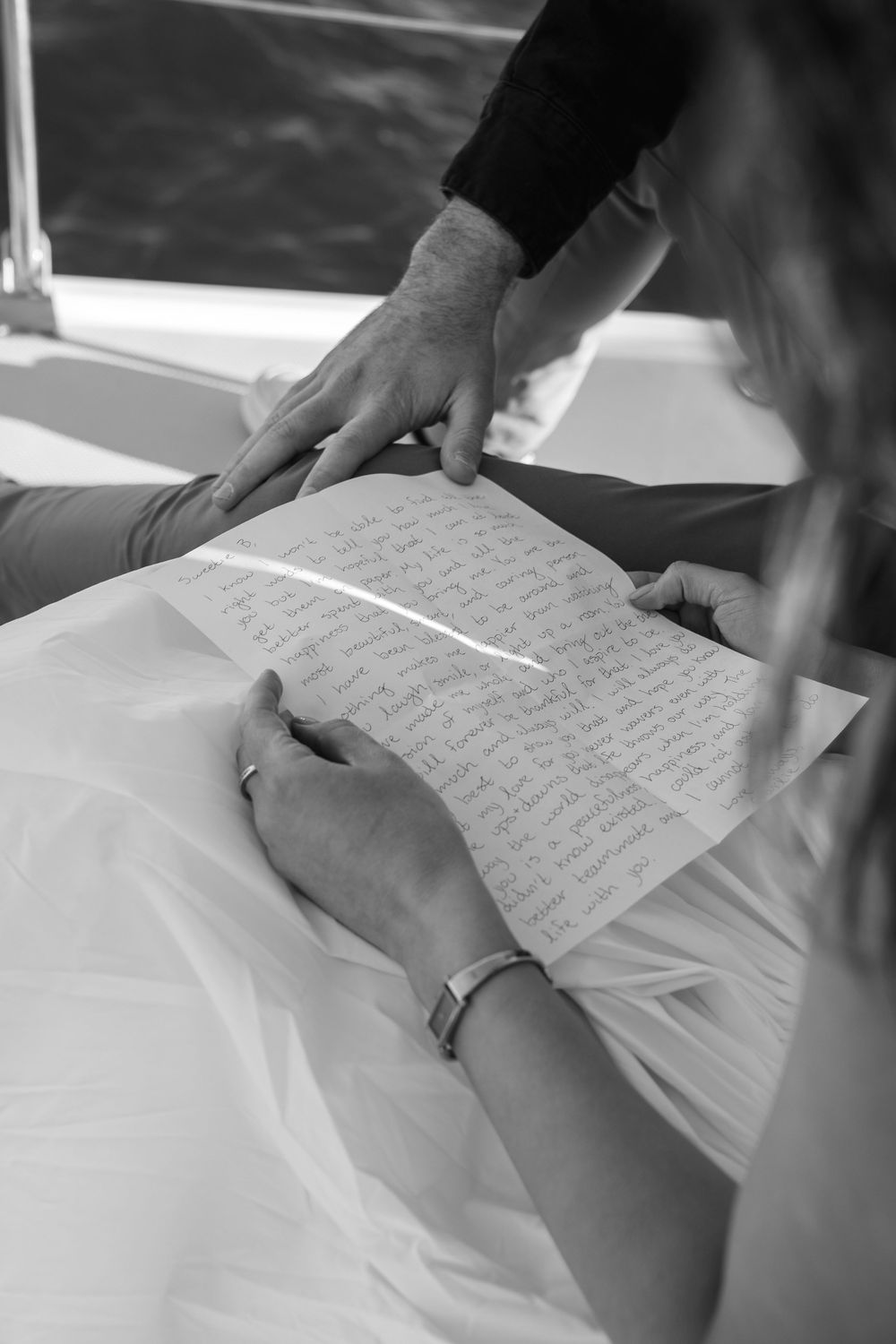 Black and white detail shots of handwritten proposal letter or vows.