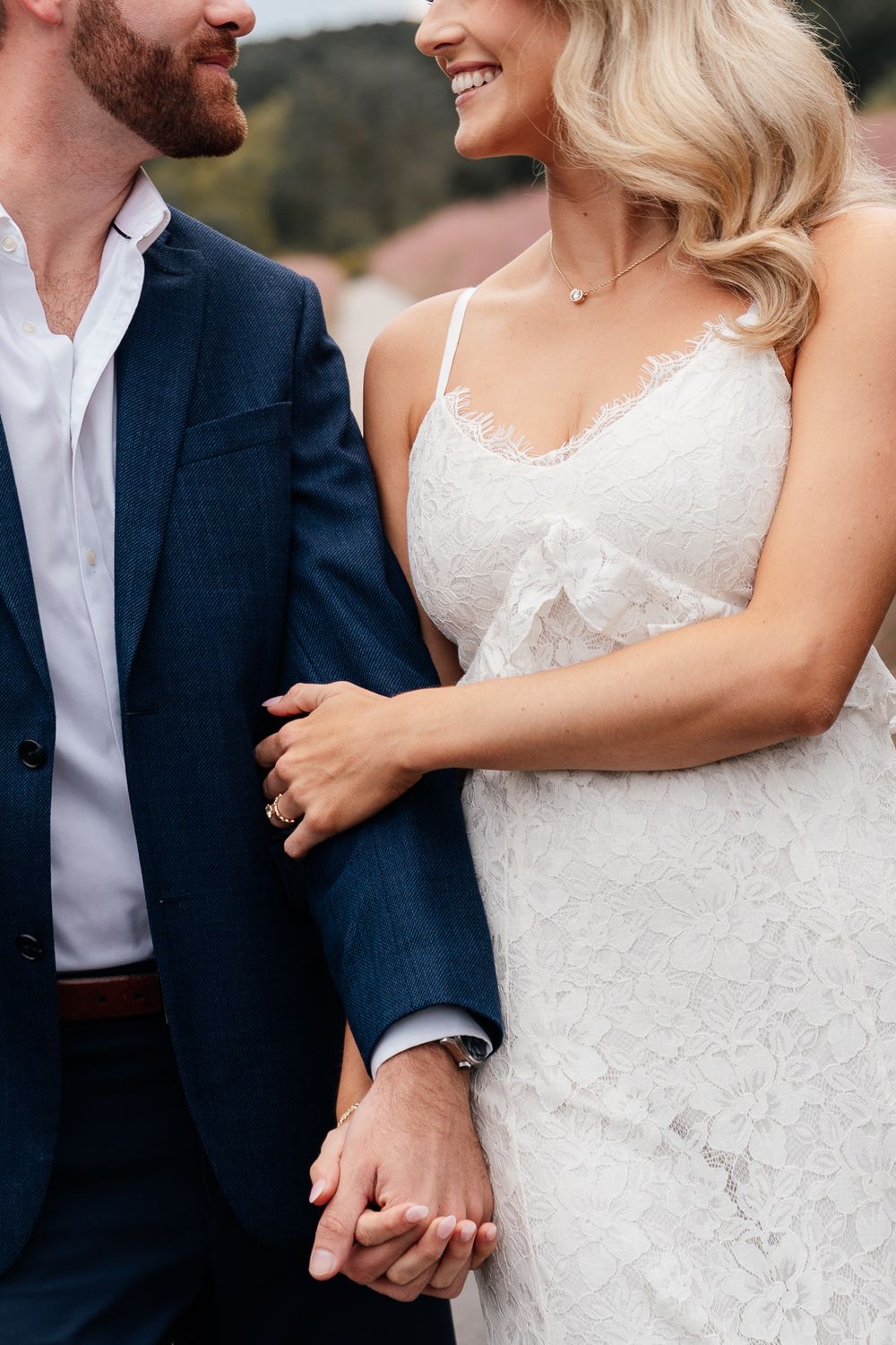A romantic wedding photoshoot showing intimate cropped shots of a couple in a white dress and navy suit.