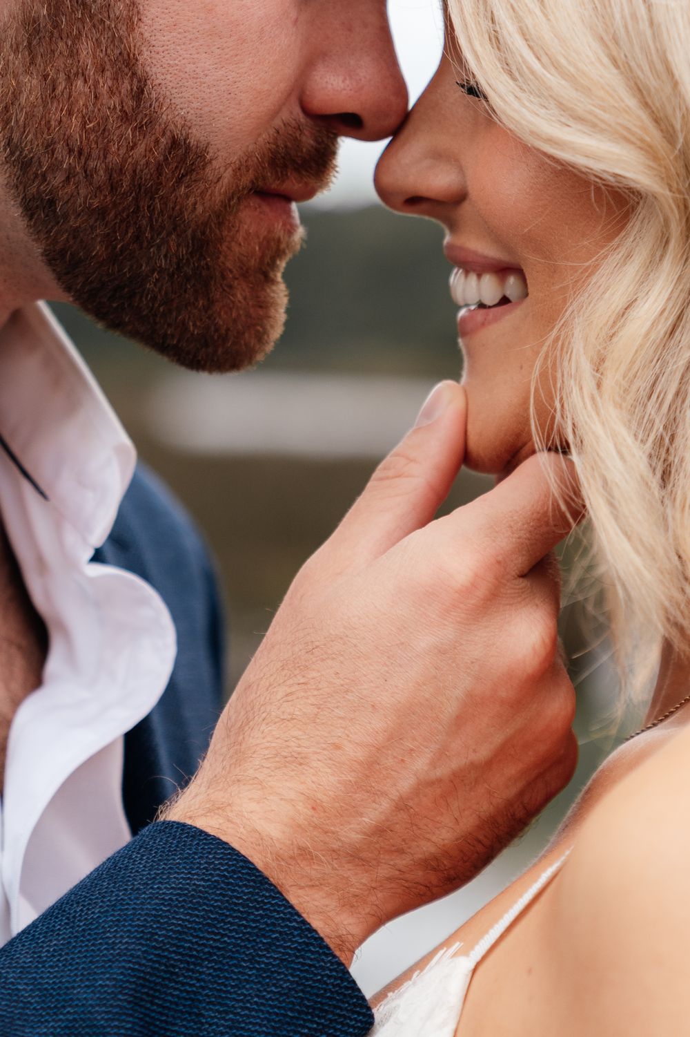 Close-up series of a romantic couple in intimate poses with the man wearing a navy shirt and the woman in white.