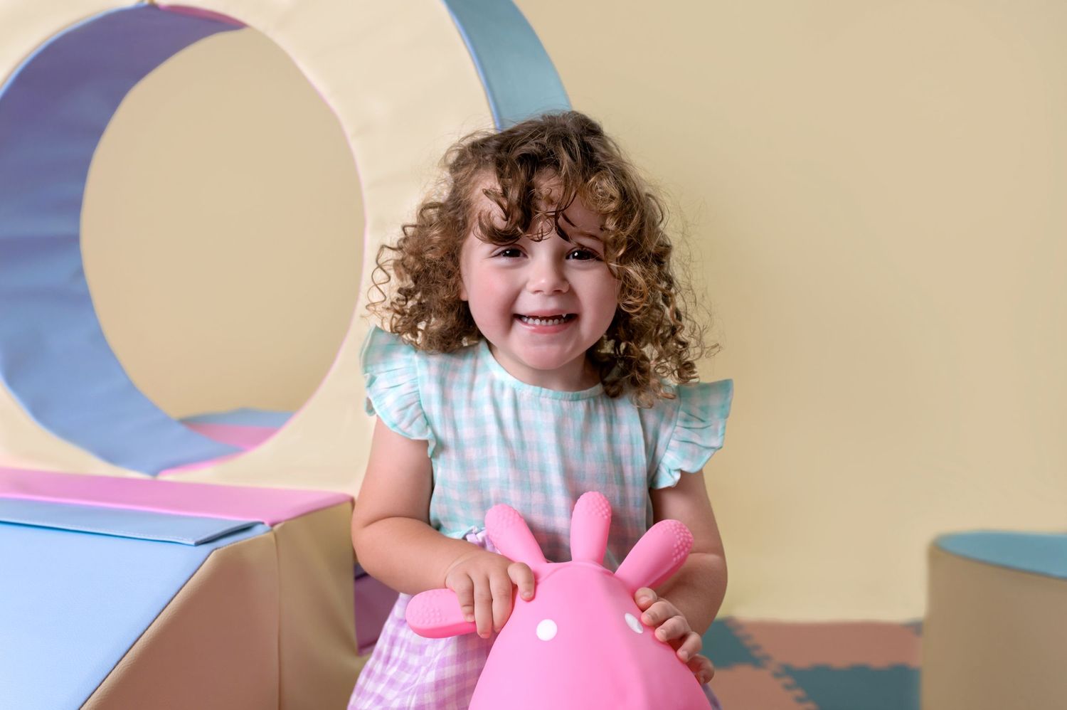 Pastel soft play setup with slide, ball pit, and climbing blocks at Yellow Blossom Photography studio in Haverhill, Suffolk.