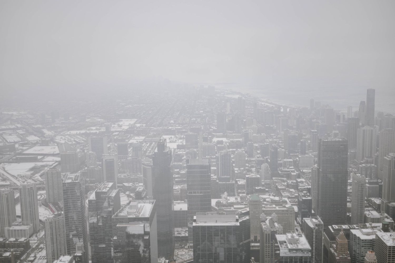 Aerial view of Chicago skyline on a foggy day showing downtown skyscrapers and urban architecture.