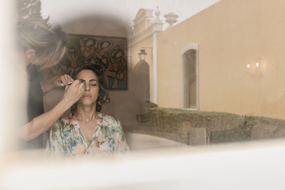 Soft focus artistic wedding preparation shot with architecture in background.