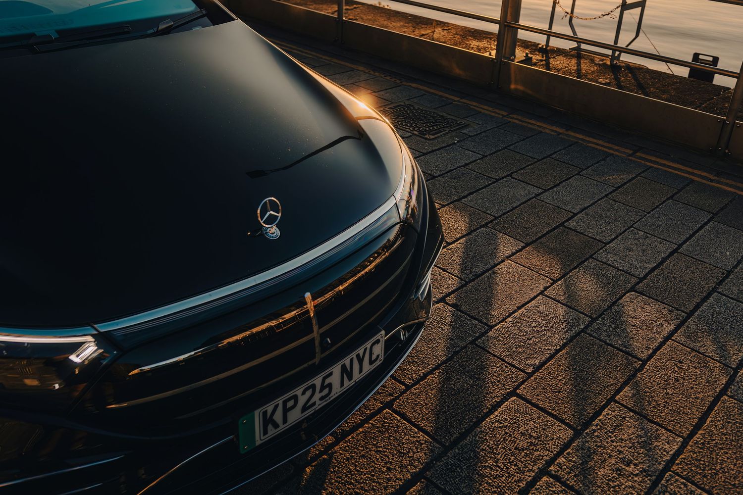 Close-up view of a BYD Dolphin Surf  rear LED light bar and badge in dramatic lighting.
