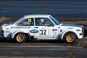 A Ford Escort races down the back of the track at Pembrey Circuit.