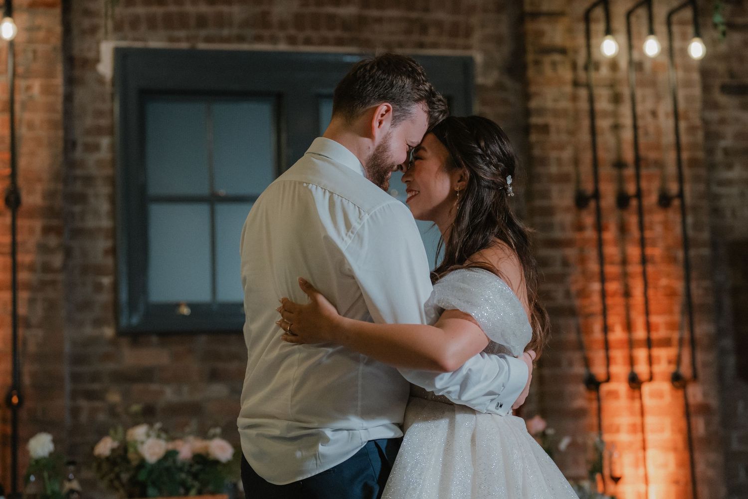 Couple shares an intimate embrace during their wedding celebration.